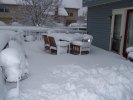 Snow on the deck, furniture.