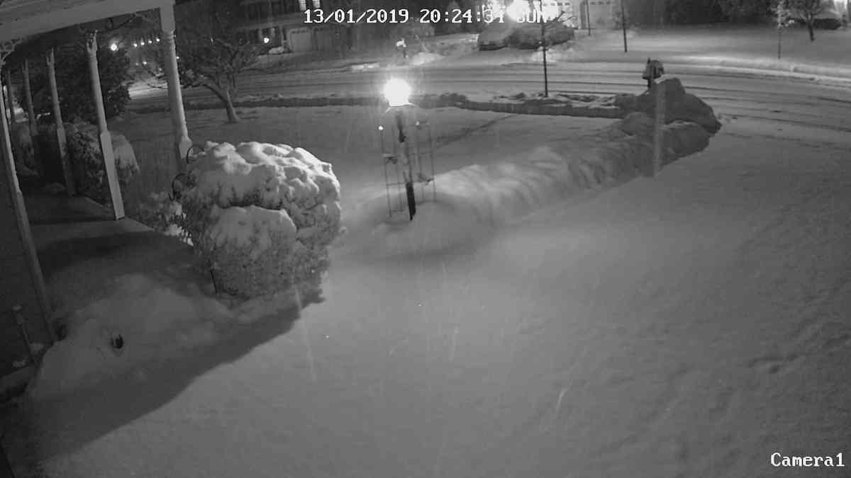 Still snowing, view from the garage outdoor cam