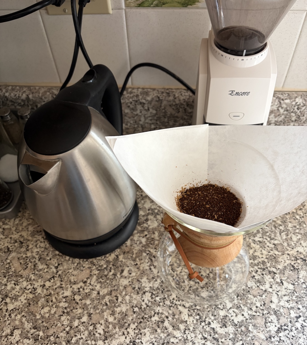 The new coffee brewing setup: a kettle, a Barzata coffee grinder, and a 6 cup glass Chemex with paper filter holding the ground coffee