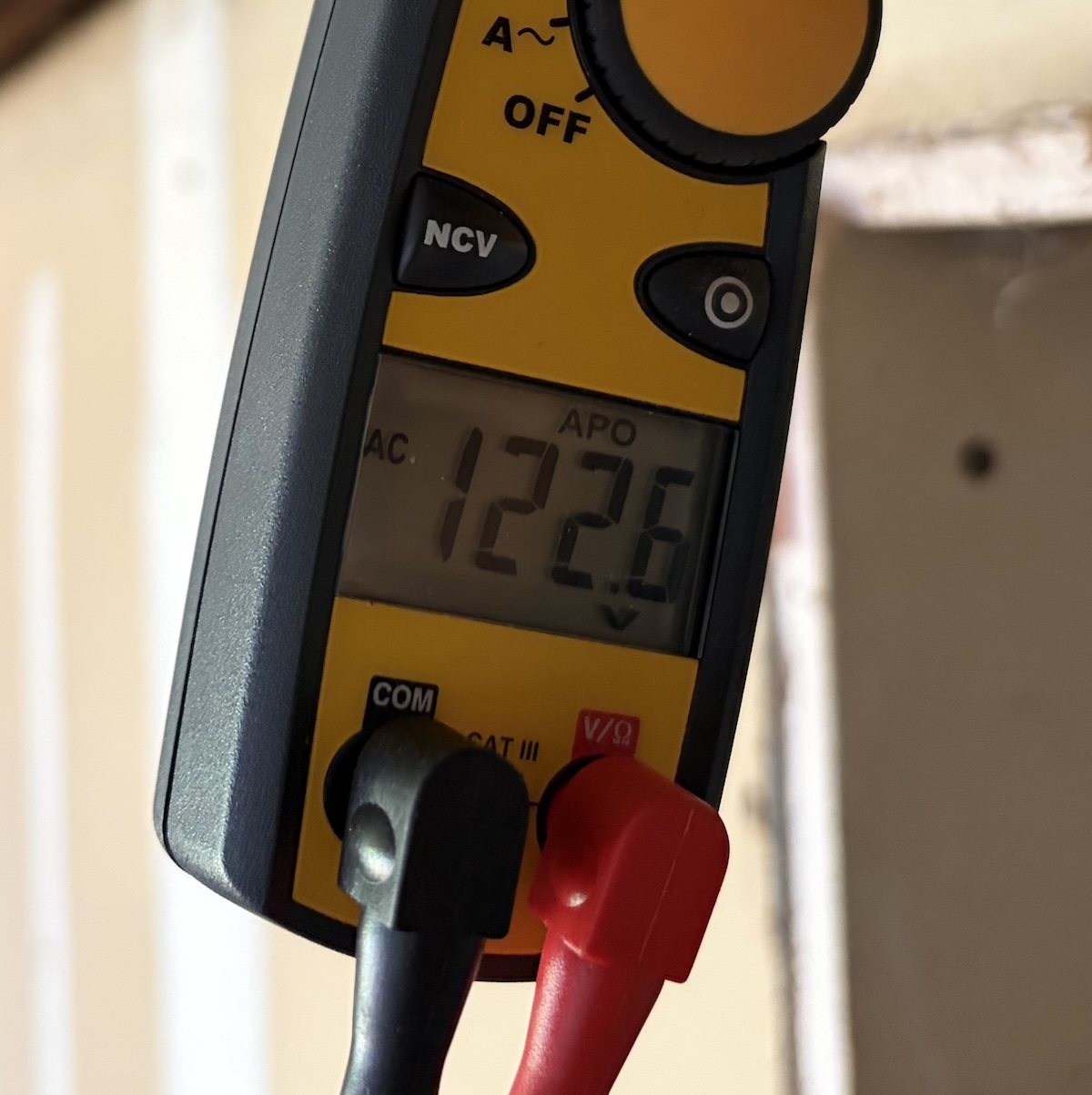 Electricity meter display showing 122.6 volts AC