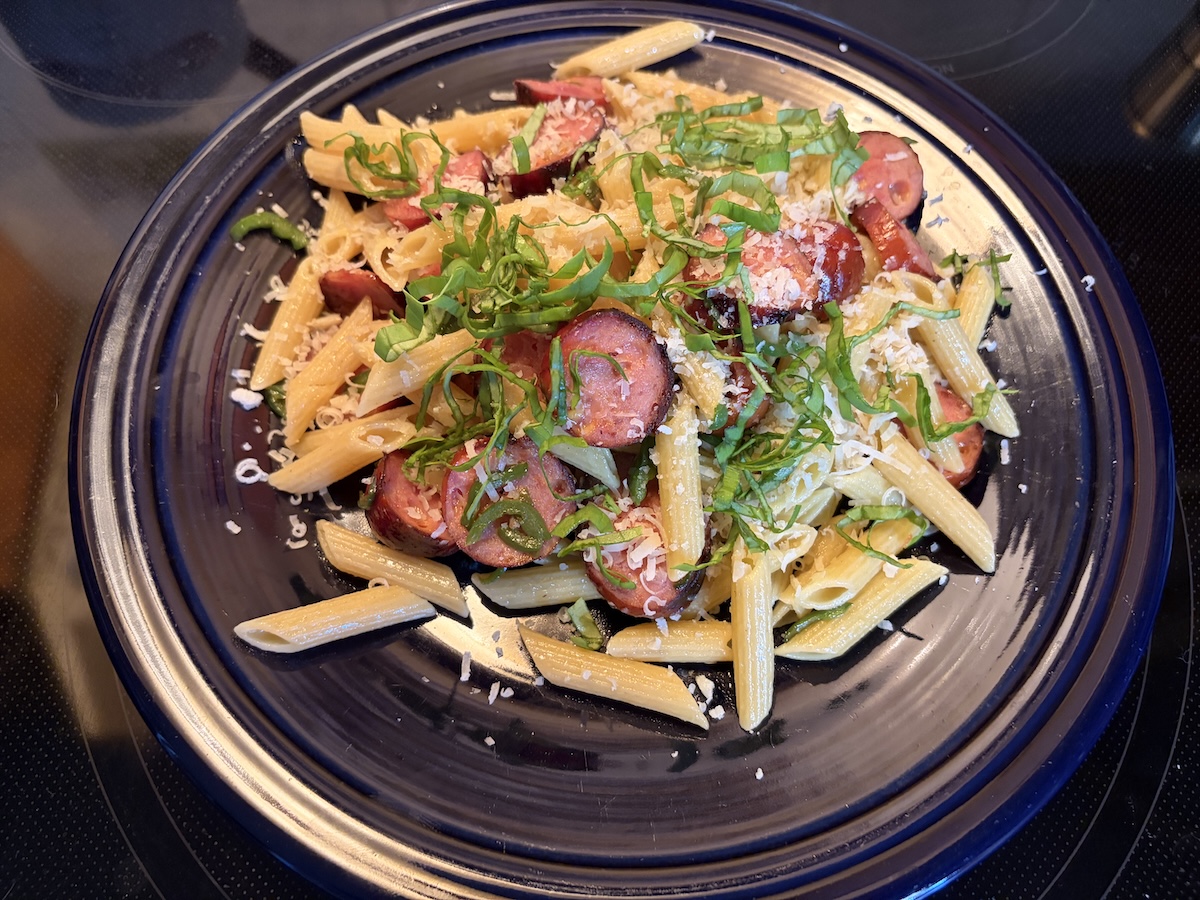 Plate with pasta, bratwurst, etc.