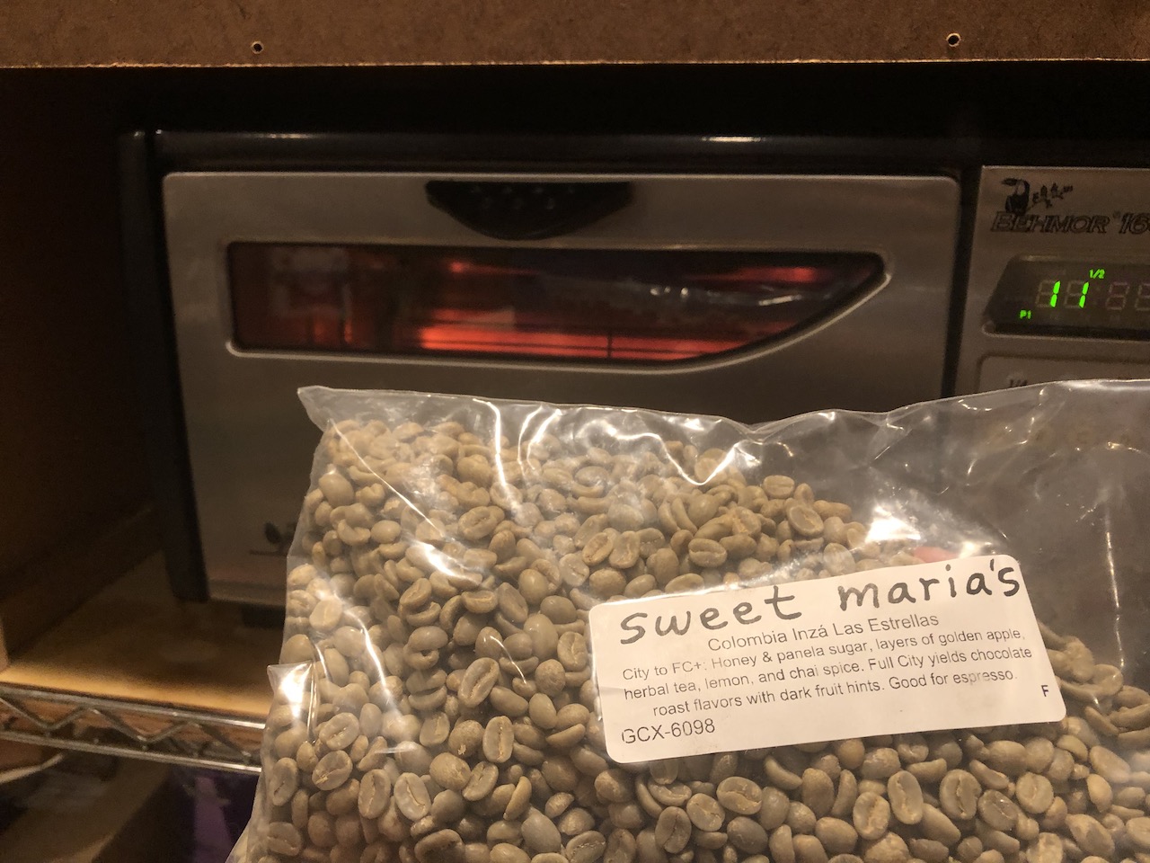 Pictured: In the background, my @behmor 1600+ coffee roaster, pre-heating (the elements are glowing red). In the foreground, a bag containing the remaining pound of Colombian green coffee beans from @sweetmarias, about to be roasted.
