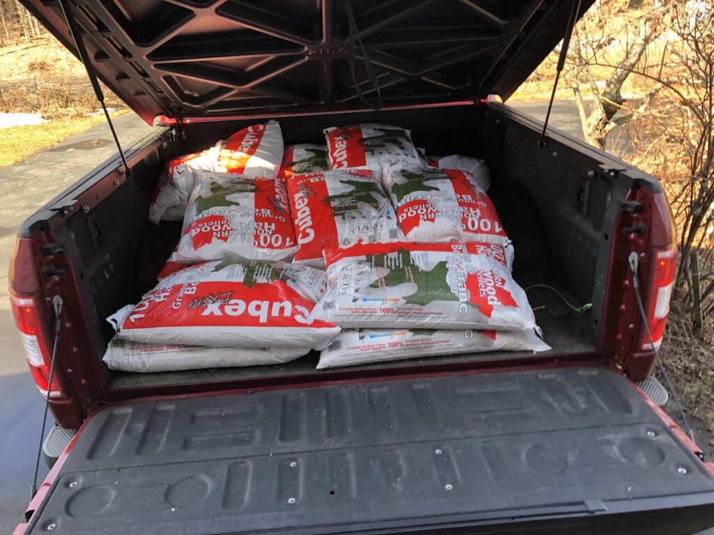 Pictured: Half a ton of hardwood pellets for our pellet stove, in 40 pound bags, sitting in the back of the F-150 truck.