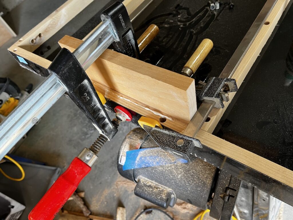 Table saw component clamped and gluing back together after the move...