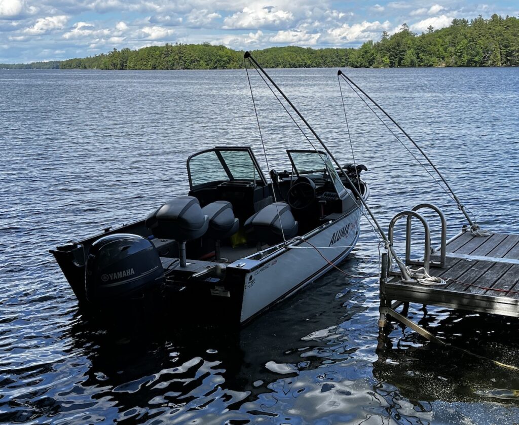 Our Alumacraft boat docked at the lake, with mooring whips.