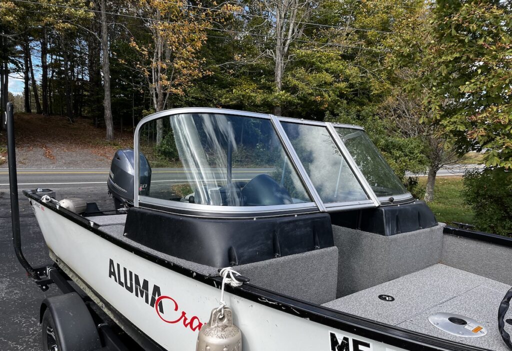 Our fishing boat in the driveway, after I replaced the starboard windscreen.