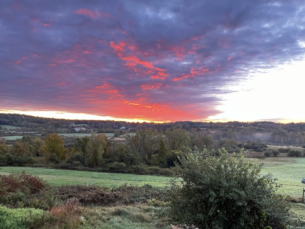 Red clouds in the sky, just before sunrise.